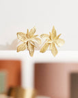 Gold Lily Flower Stud Earrings – Elegant Textured Floral Jewelry