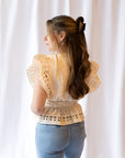 Noemi Eyelet Trim Peplum Top